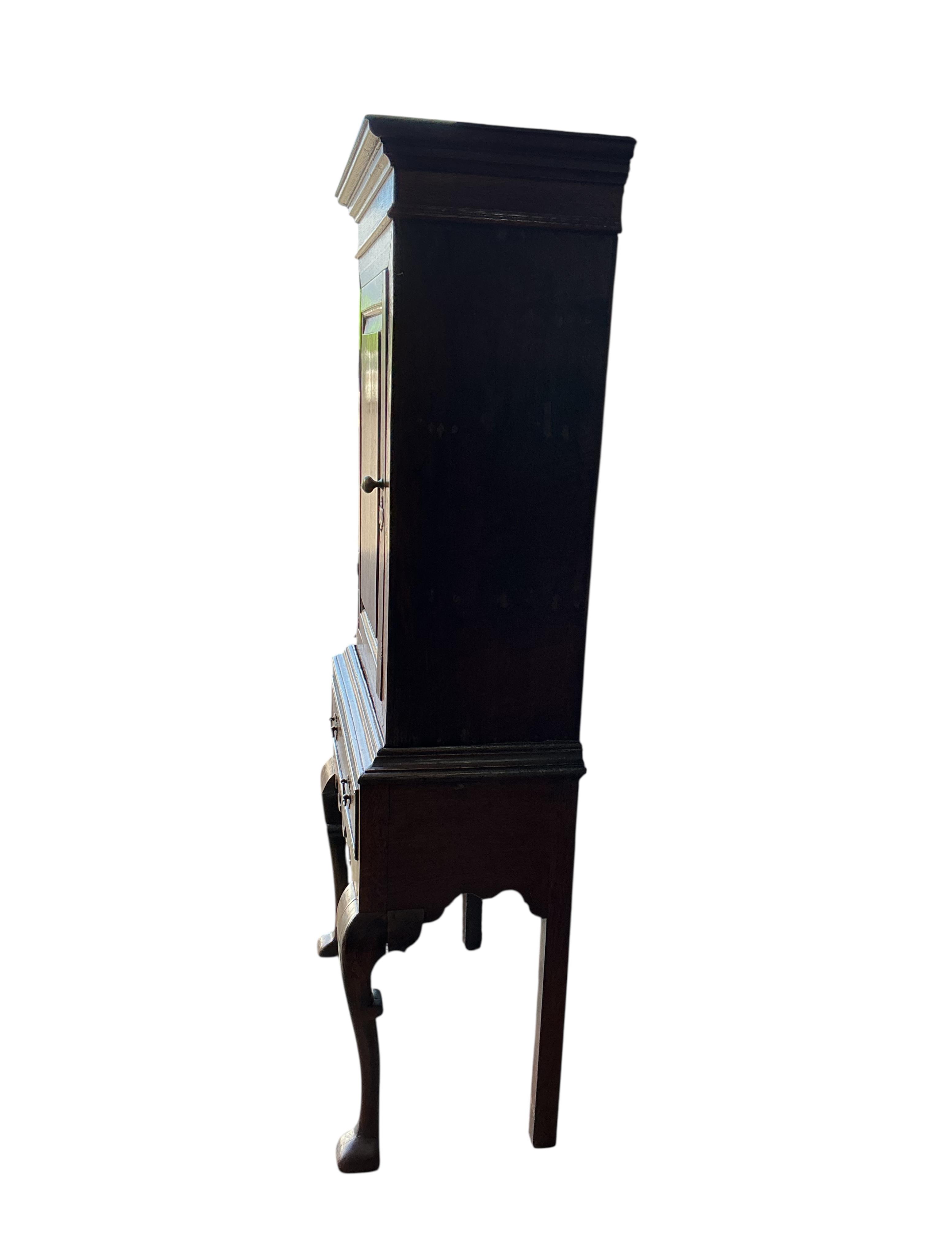 An 18th century and later inlaid oak cabinet on stand, width 72cm, depth 36cm, height 162cm